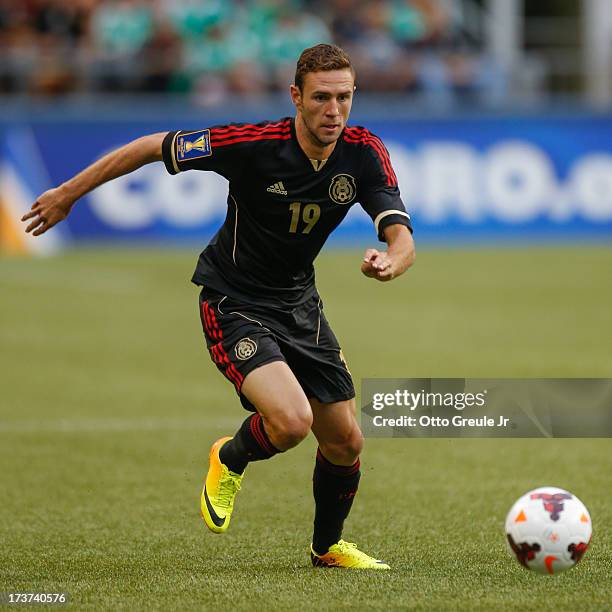 Miguel Layun of Mexico dribbles against Canada at CenturyLink Field on July 11, 2013 in Seattle, Washington.