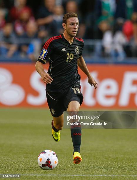 Miguel Layun of Mexico dribbles against Canada at CenturyLink Field on July 11, 2013 in Seattle, Washington.