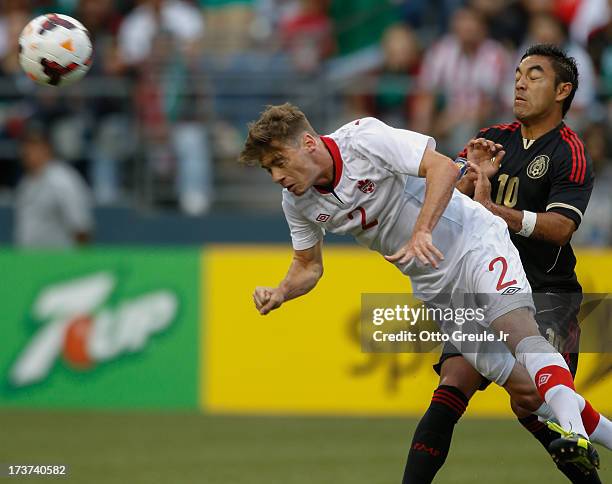 Nikolas Ledgerwood of Canada heads the ball against Marco Fabian of Mexico at CenturyLink Field on July 11, 2013 in Seattle, Washington.