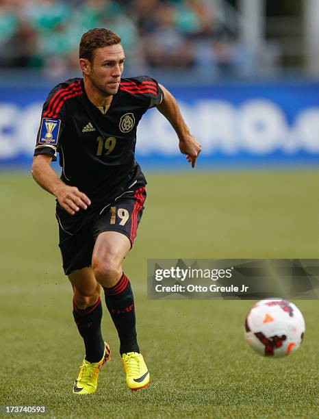 Miguel Layun of Mexico dribbles against Canada at CenturyLink Field on July 11, 2013 in Seattle, Washington.