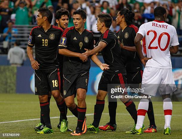 Raul Jimenez of Mexico is congratulated by teammates after scoring a goal against Canada at CenturyLink Field on July 11, 2013 in Seattle, Washington.