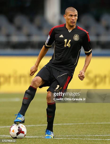 Jorge Enriquez of Mexico dribbles against Canada at CenturyLink Field on July 11, 2013 in Seattle, Washington.