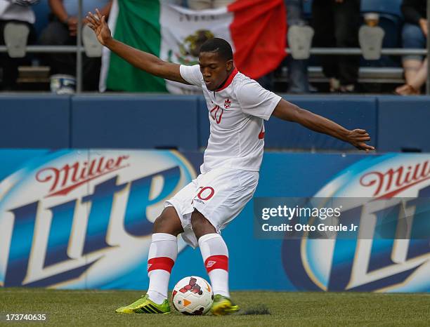 Doneil Henry of Canada passes against Mexico at CenturyLink Field on July 11, 2013 in Seattle, Washington.