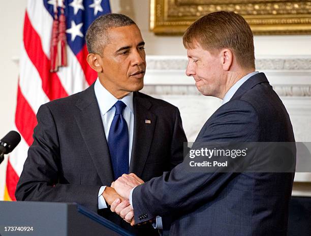 President Barack Obama shakes the hand of Richard Cordray after his confirmation as Director of the Consumer Financial Protection Bureau in the State...