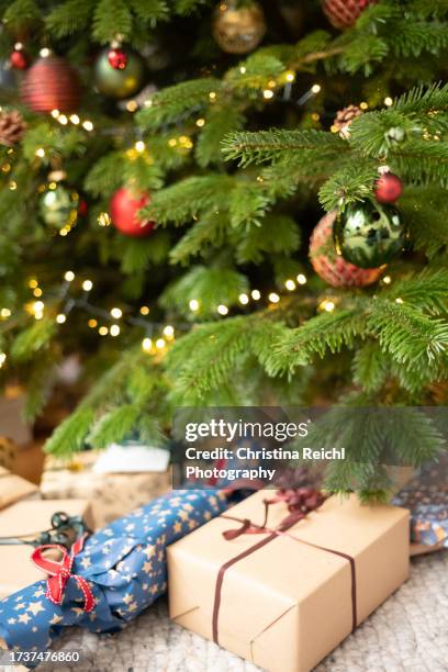 many christmas presents under wonderful christmas tree - england v germany stock pictures, royalty-free photos & images