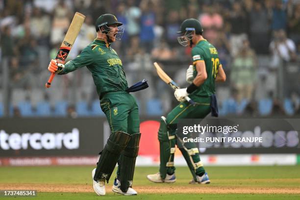 South Africa's Heinrich Klaasen celebrates after scoring a century next to Marco Jansen during the 2023 ICC Men's Cricket World Cup one-day...