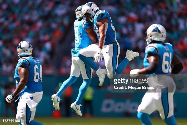 Bryce Young of the Carolina Panthers celebrates a touchdown with Tommy Tremble during the second quarter in the game against the Miami Dolphins at...