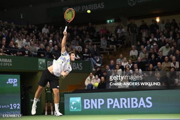 Pavel Kotov of Russia serves the ball to Miomir Kecmanovic of Serbia during their semifinal match at the ATP Nordic Open tennis tournament in the...