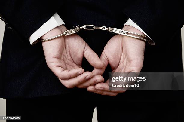 handcuffed hands - arrest stock pictures, royalty-free photos & images