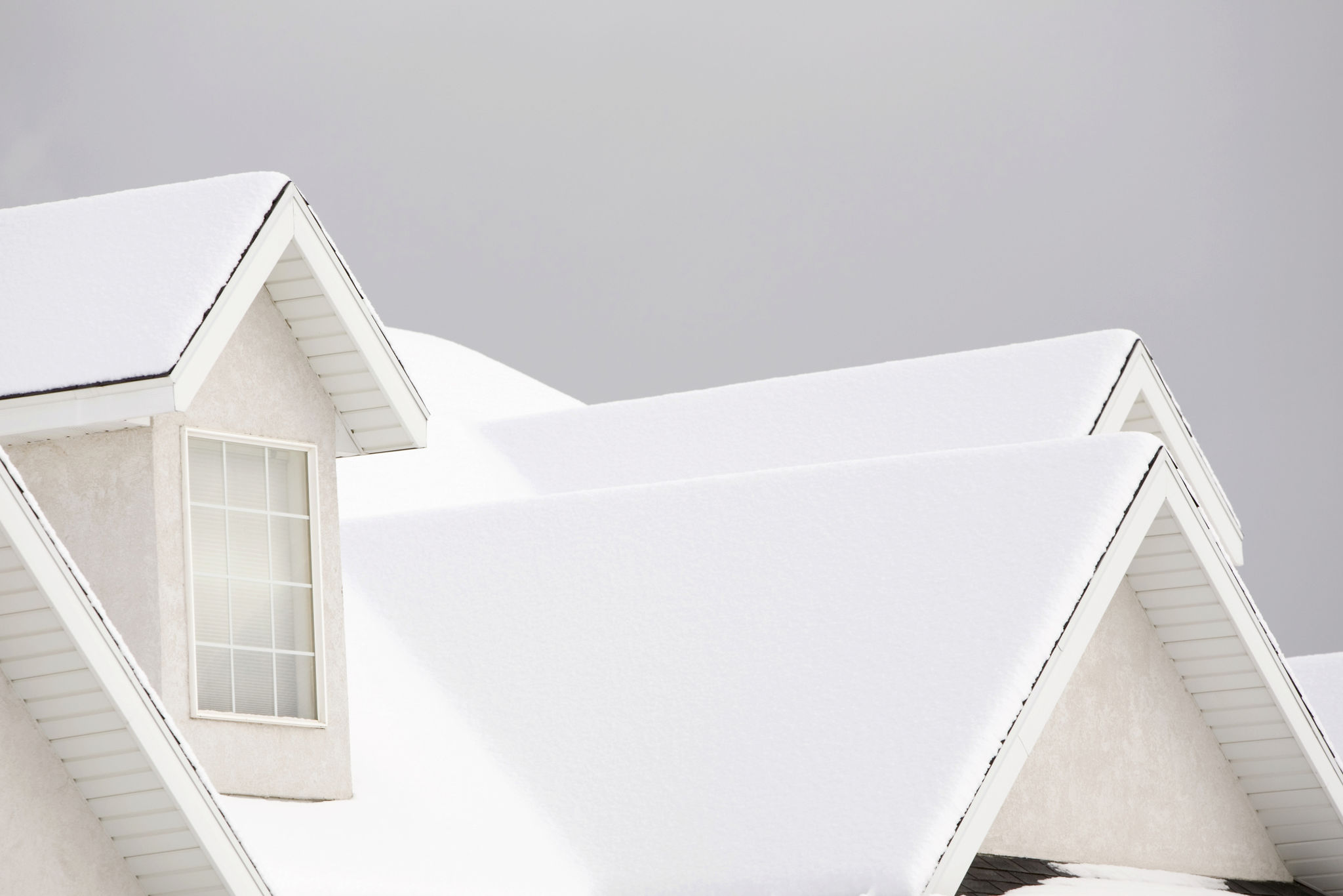 Snow-covered roof on a Utah home, highlighting the importance of timing roof replacements in winter for Ogden homeowners. Snow-covered roof on a Utah home, highlighting the importance of timing roof replacements in winter for Ogden homeowners.