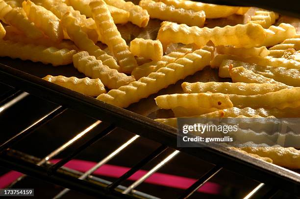 french fries in the oven - prepared potato stock pictures, royalty-free photos & images