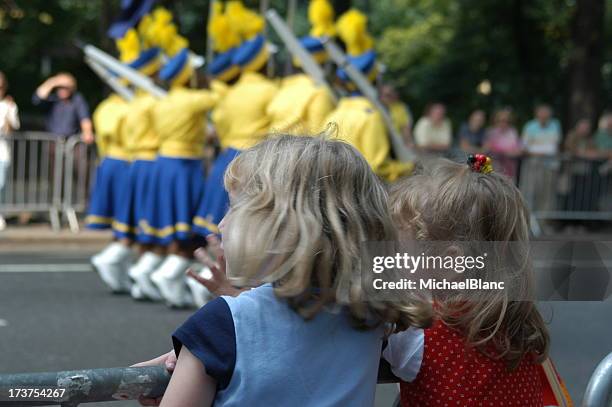 infant watching cheerleaders near the road - parade float stock pictures, royalty-free photos & images