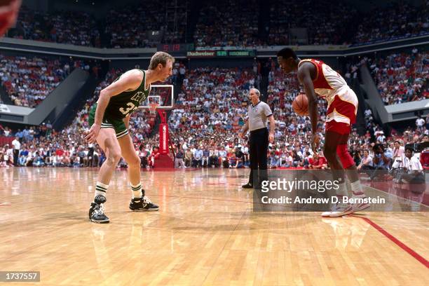 Doninique Wilkins of the Atlanta Hawks squares off against Larry Bird of the Boston Celtics during the 1987 NBA game at the Omni in Atlanta, Georgia....