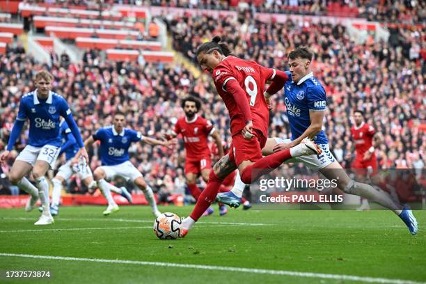 Liverpool's Uruguayan striker Darwin Nunez crosses the ball during the English Premier League football match between Liverpool and Everton at Anfield...