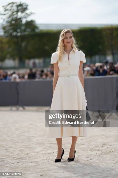 Beatrice Borromeo wears a white gathered midi dress, a belt, black pumps / shoes, outside Dior, during the Womenswear Spring/Summer 2024 as part of...