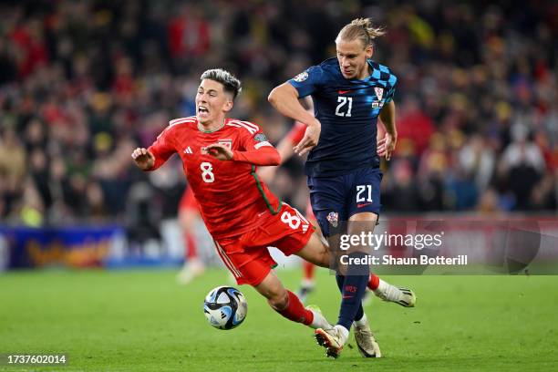 Harry Wilson of Wales is tackled by Domagoj Vida of Croatia during the UEFA EURO 2024 European qualifier match between Wales and Croatia at Cardiff...