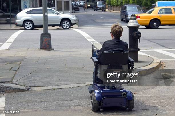 disabled crossing the street - mobility scooters stock pictures, royalty-free photos & images