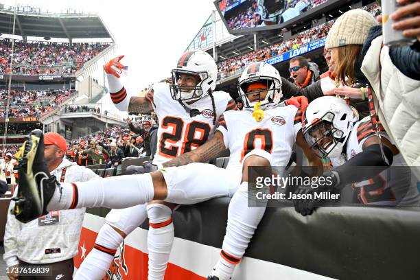 Mike Ford of the Cleveland Browns, Greg Newsome II of the Cleveland Browns and Grant Delpit of the Cleveland Browns celebrate a defensive stop during...
