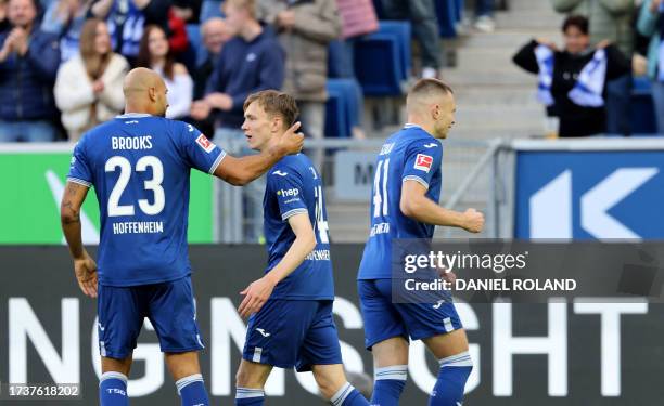 Hoffenheim's German forward Maximilian Beier is congratulated by Hoffenheim's German defender John Anthony Brooks after scoring the 1-0 opening goal...