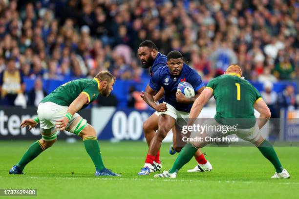 Jonathan Danty of France runs with the ball whilst under pressure from Duane Vermeulen and Steven Kitshoff of South Africa during the Rugby World Cup...