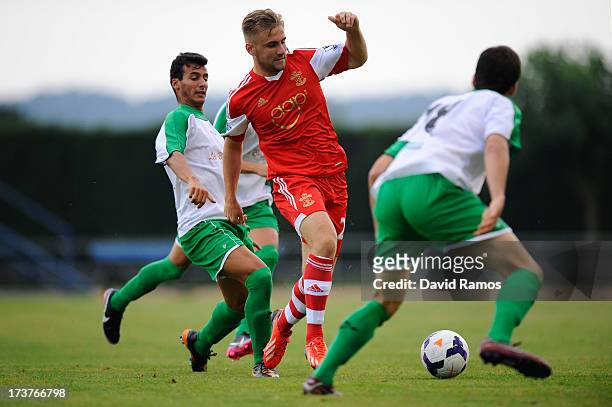Luke Shaw of Southampton duels for the ball during a friendly match between Southampton FC and UE Llagostera at the Josep Pla i Arbones Stadium on...