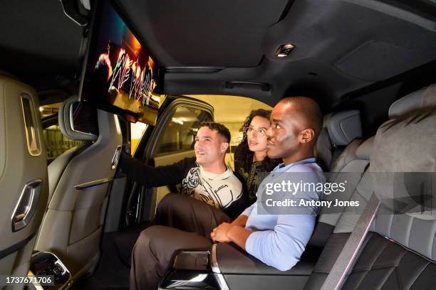 Winners of the BMW Filmmaking Challenge in partnership with the BFI, Jason Bradbury and Cheri Darbon with Ncuti Gatwa in the BMW i7 watching "We...