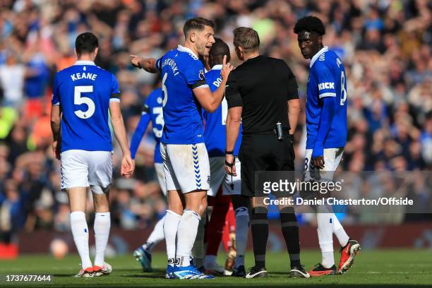 James Tarkowski of Everton argues with referee Craig Pawson during the Premier League match between Liverpool FC and Everton FC at Anfield on October...