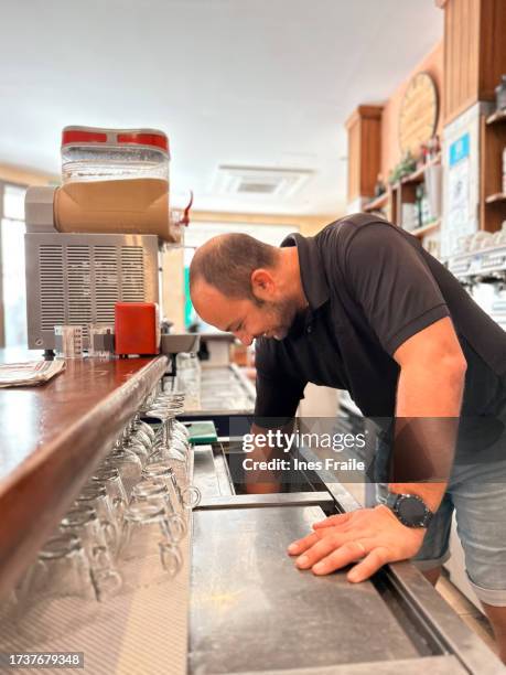 waiter working in a rural town bar - dona ines imagens e fotografias de stock