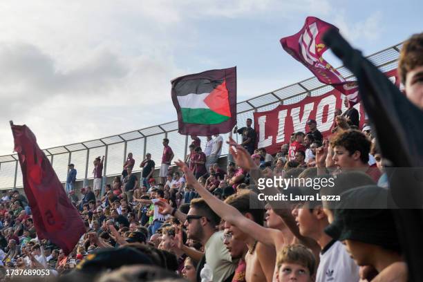 Fans of US Livorno Calcio football team wave a Palestinian flag during the US Livorno V Tau match on October 15, 2023 in Livorno, Italy. On October...