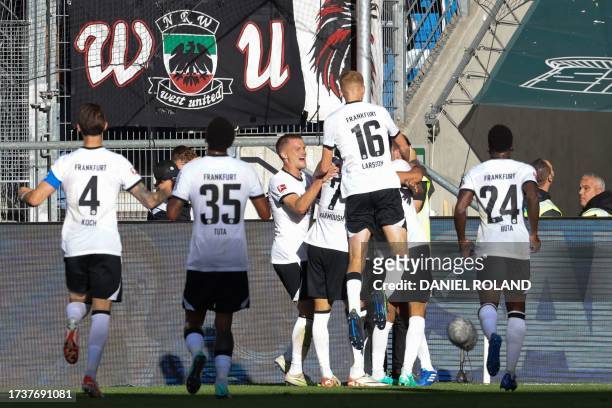 Hoffenheim's players celebrate the 3-1 goal scored by Frankfurt's Tunisian midfielder Ellyes Skhiri during the German first division Bundesliga...