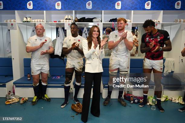 Catherine, Princess of Wales and Patron of the Rugby Football Union congratulates the England team on their victory in the changing room following...