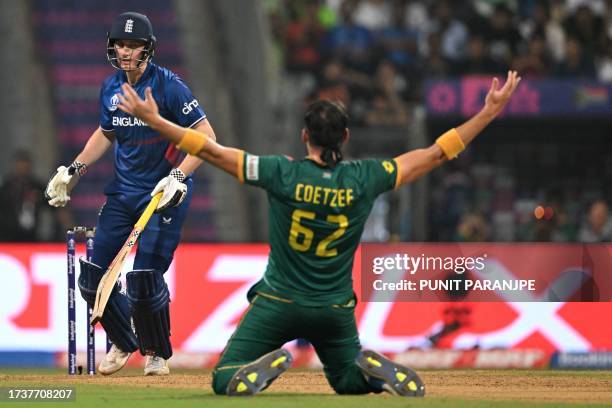 South Africa's Gerald Coetzee celebrates after taking the wicket of England's Harry Brook during the 2023 ICC Men's Cricket World Cup one-day...