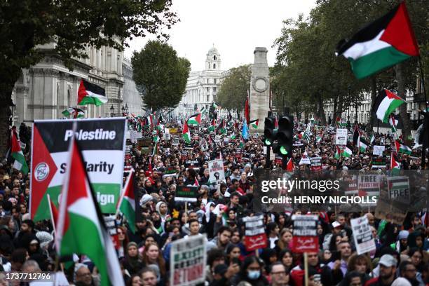 People take part in a 'March For Palestine', in London on October 21 to "demand an end to the war on Gaza". The UK has pledged its support for Israel...