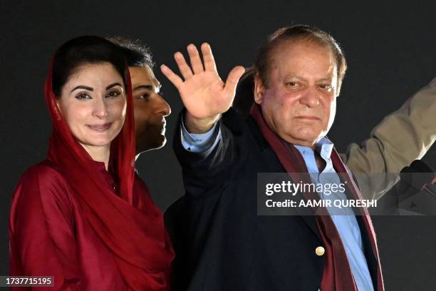 Pakistan's former Prime Minister Nawaz Sharif stands beside his daughter Maryam Nawaz as he waves to his supporters gathered at a park during an...