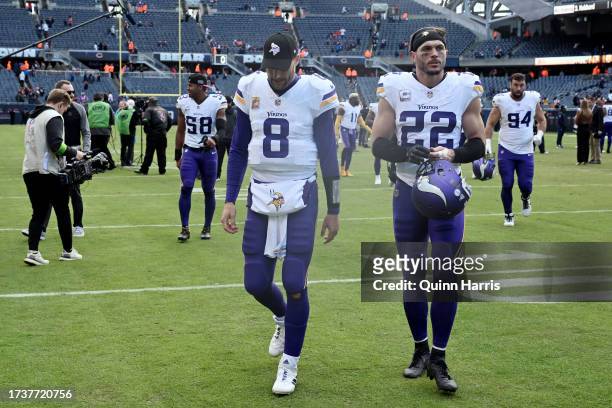 Kirk Cousins and Harrison Smith of the Minnesota Vikings walk off the field after a win over the Chicago Bears at Soldier Field on October 15, 2023...