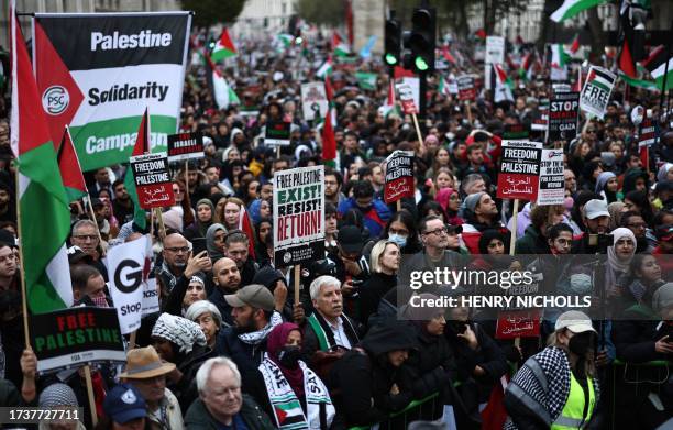 People take part in a 'March For Palestine', in London on October 21 to "demand an end to the war on Gaza". The UK has pledged its support for Israel...