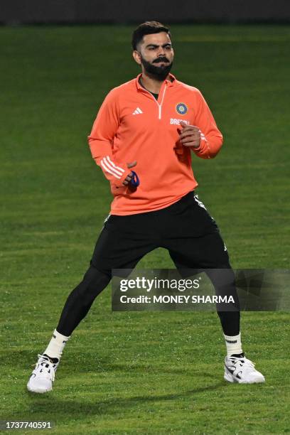 India's Virat Kohli attends a practice session on the eve of their 2023 ICC Men's Cricket World Cup one-day international match against New Zealand...