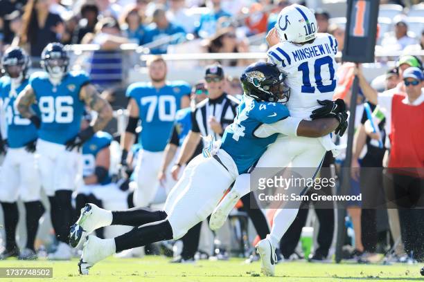 Gardner Minshew of the Indianapolis Colts is tackled by Travon Walker of the Jacksonville Jaguars during the fourth quarter at EverBank Stadium on...
