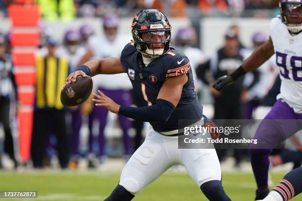 Quarterback Justin Fields of the Chicago Bears sets to throw the ball during an NFL football game against the Minnesota Vikings at Soldier Field on...