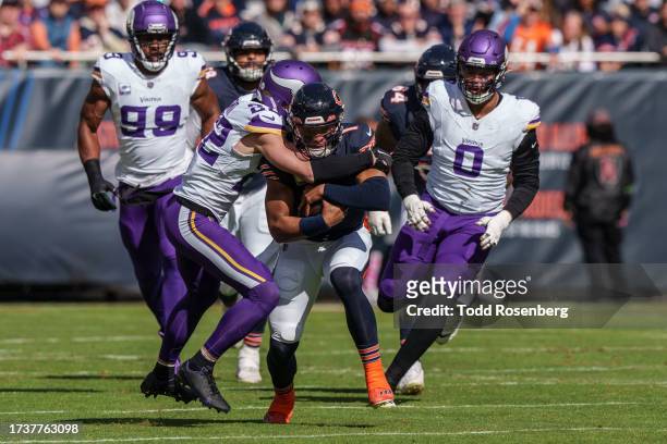 Quarterback Justin Fields of the Chicago Bears is tackled by safety Harrison Smith of the Minnesota Vikings during an NFL football game at Soldier...
