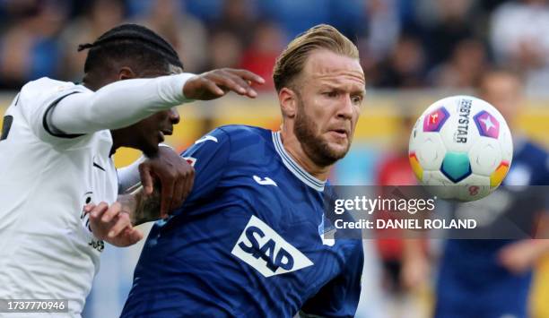 Hoffenheim's German defender Kevin Vogt and Frankfurt's French midfielder Eric Ebimbe vie for the ball during the German first division Bundesliga...