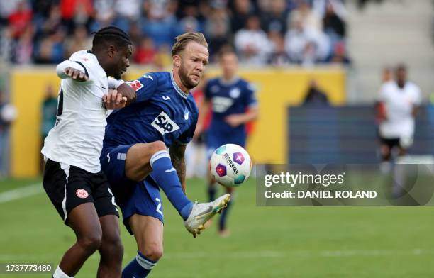 Hoffenheim's German defender Kevin Vogt and Frankfurt's French midfielder Eric Ebimbe vie for the ball during the German first division Bundesliga...