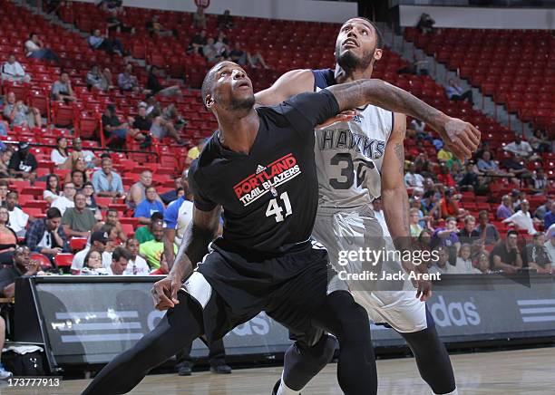 Thomas Robinson of the Portland Trail Blazers guards Mike Scott of the Atlanta Hawks during the NBA Summer League game between the Atlanta Hawks and...