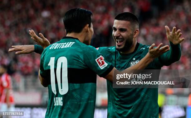 Stuttgart's German forward Deniz Undav celebrates with his teammate Stuttgart's South Korean midfielder Wooyeong Jeong after scoring the 0-3 goal...