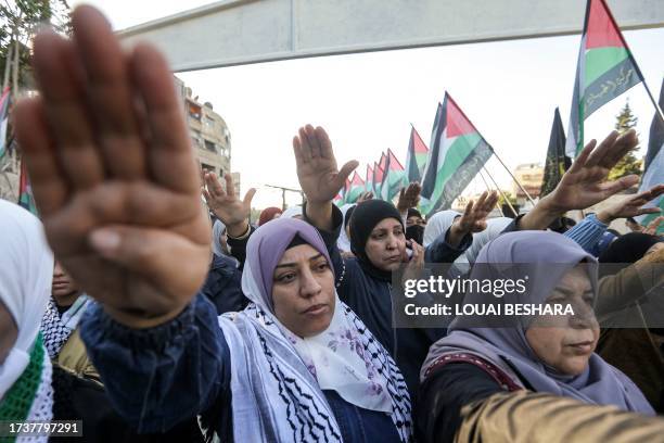 Demonstrators gesture during a rally in solidarity with Palestinians in the Gaza Strip organised by the Palestinian Islamic Jihad faction at the...