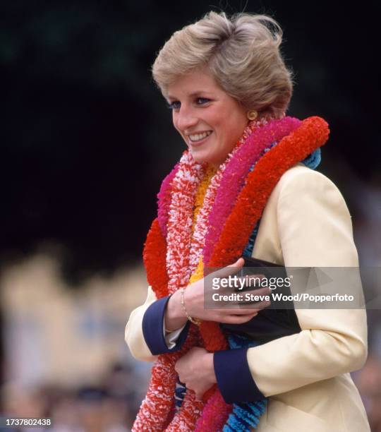 Princess Diana is presented with garlands on a visit to Has Tamar, a British Forces shore base, during an official visit to Hong Kong with her...