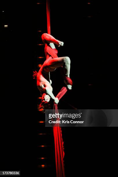 Performers perform during the "Cirque Du Soleil's Quidam" Press Preview at The George Mason University Patriot Center on July 17, 2013 in Fairfax,...