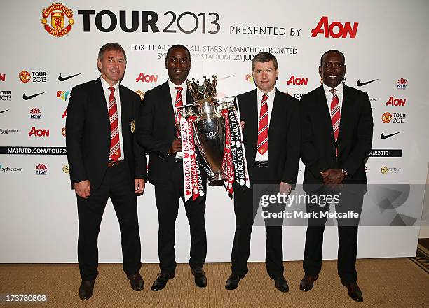 Bryan Robson, Andy Cole, Dennis Irwin and Dwight Yorke pose with the Barclays Premier League trophy during the official Manchester United official...
