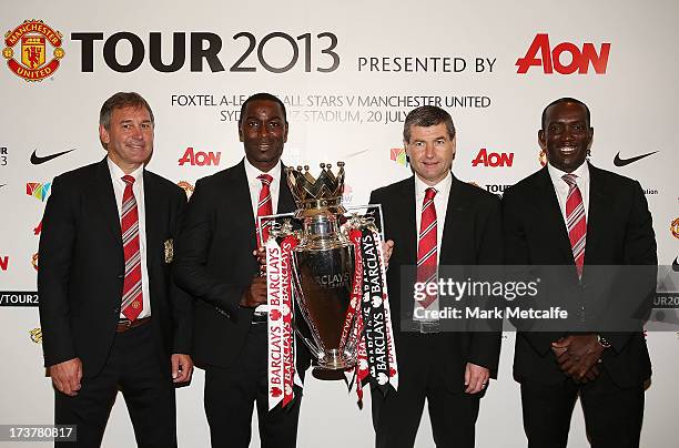 Bryan Robson, Andy Cole, Dennis Irwin and Dwight Yorke pose with the Barclays Premier League trophy during the official Manchester United official...