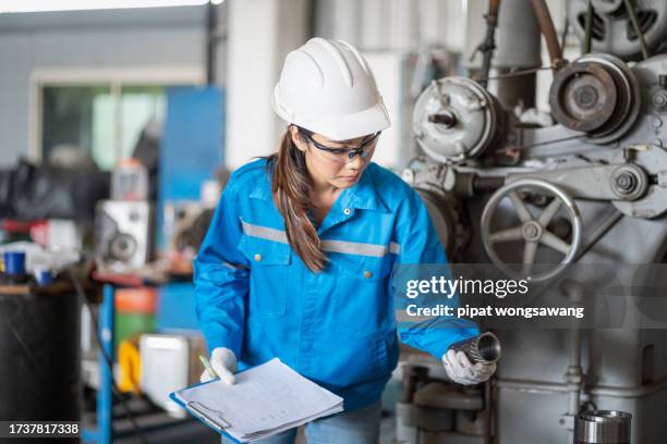 maintenance engineer inspects machinery in a cardboard parts factory. - consultation lake fotografías e imágenes de stock